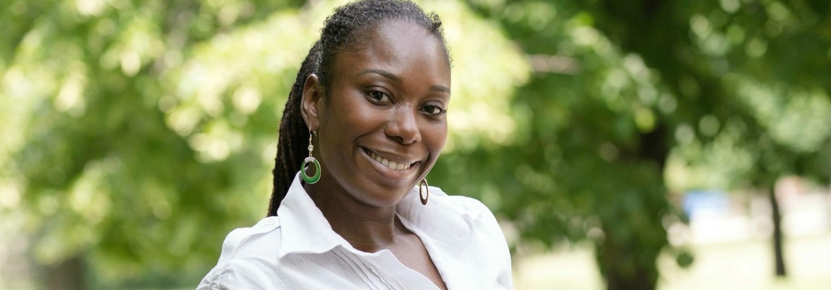 A woman smiling and looking at the camera.