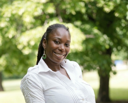 A woman smiling and looking at the camera.