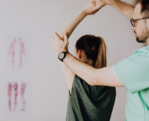 A chiropractor helping a patient