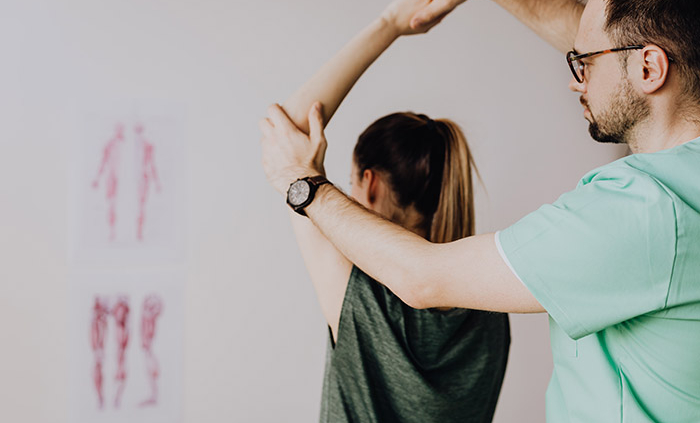 A chiropractor helping a patient