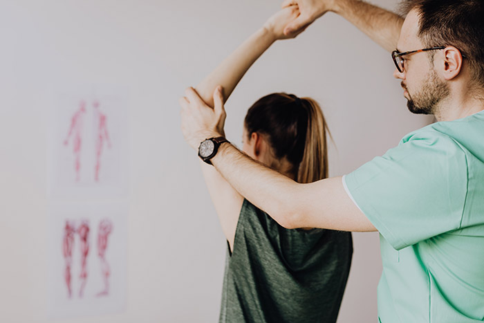 A chiropractor helping a patient